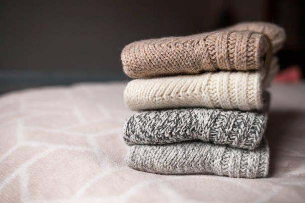 istock Knitted wool clothes on the bed. Retro style. 1160662163