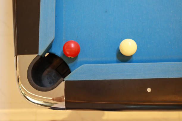 istock red and white billiard ball on blue pool table 1160663794