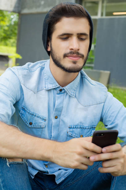 istock Young man using his phone. Outdoors. 1160667039