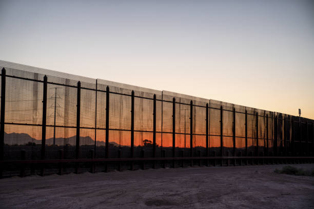 The International Border Wall Near Socorro, Texas and Ciudad Juarez, Mexico A view of the Border fence-like wall between the United States and Mexico in the early evening and sundown ciudad juarez photos stock pictures, royalty-free photos & images