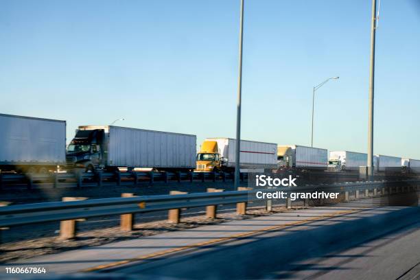 A Long Line Of Semi Trucks Waiting To Cross The Border From The United States Into Mexico Stock Photo - Download Image Now