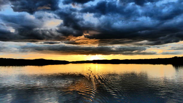 istock Threatening sky in a sunset that reflects on the water 1160675119