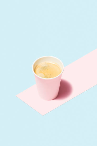 Coffee in paper cup on color background