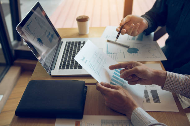 istock Two business partnership coworkers and gesturing with discussing a financial planning graph and company during a budget meeting in office room. 1160687845