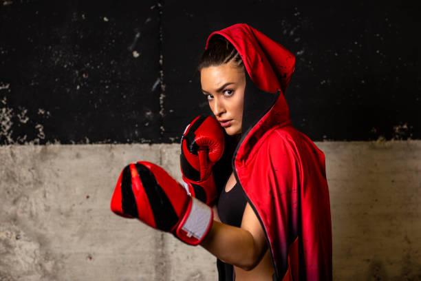 istock Strong young woman in red preparing for training at gym 1160691972