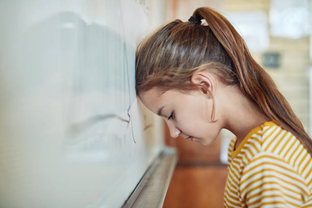Information overload Shot of a young girl leaning against a board in a classroom at school information overload photos stock pictures, royalty-free photos & images