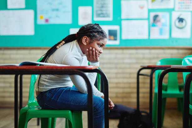 it's no fun being by yourself - studying child female student imagens e fotografias de stock