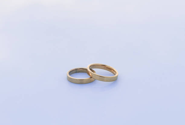 istock Two precious gold rings on a white table - Brilliant and precious rings 1160696755