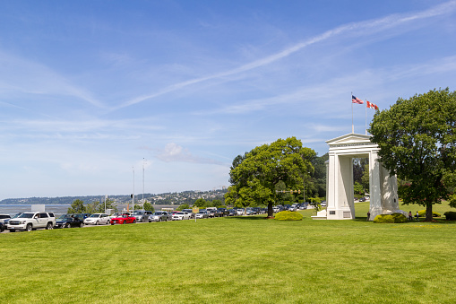 Vancouver-Blaine Hwy, Canada - 02 June 2019: Cars lining up to cross the Canada - US Peace Arch border crossing the Peace Arch Park