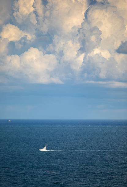 Cloudscape and boat over sea Miami Florida