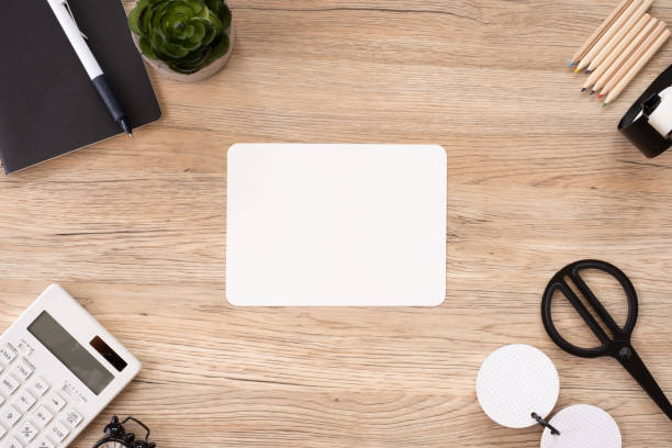 istock top view blank white paper note with office stationery on wooden table with copy space.student stuff on desk.education concept. 1160698724