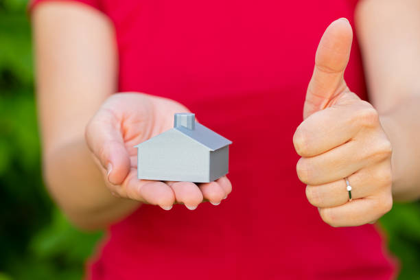 istock 3d printed house in female hands 1160699116