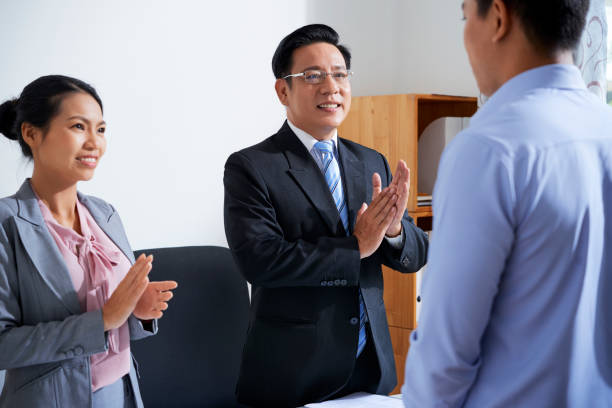istock Business people applauding coworker 1160699276