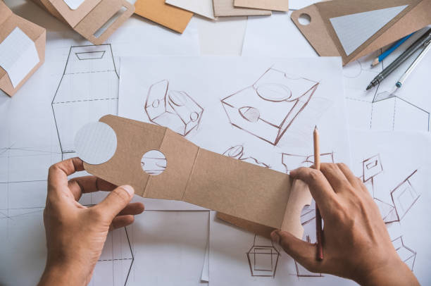 istock Designer sketching drawing design Brown craft cardboard paper product eco packaging mockup box development template package branding Label . designer studio concept . 1160699340