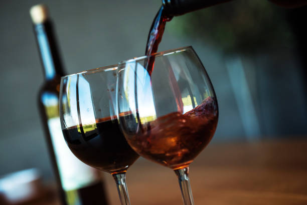 istock Pouring red wine on a wooden oak table 1160700005