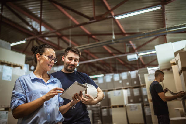 istock Warehouse supervisor walking and talking with senior manager 1160700193
