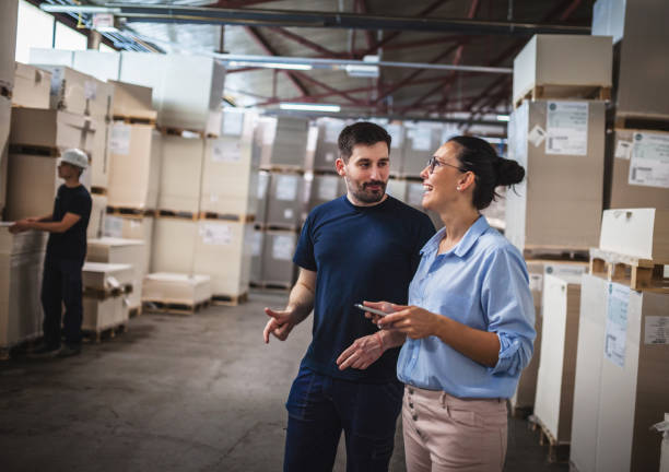 istock Warehouse supervisor walking and talking with senior manager 1160700200