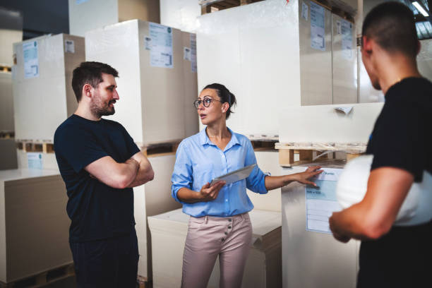 istock Warehouse supervisor walking and talking with senior manager 1160700246