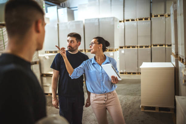 istock Warehouse supervisor walking and talking with senior manager 1160700314