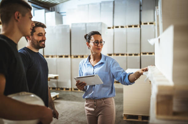 istock Warehouse supervisor walking and talking with senior manager 1160700316
