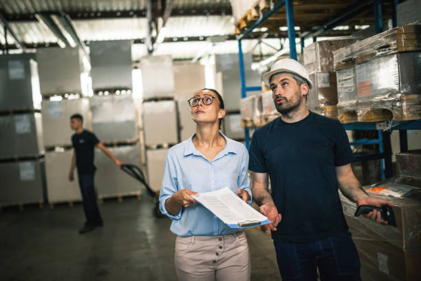 istock Warehouse supervisor walking and talking with senior manager 1160701134