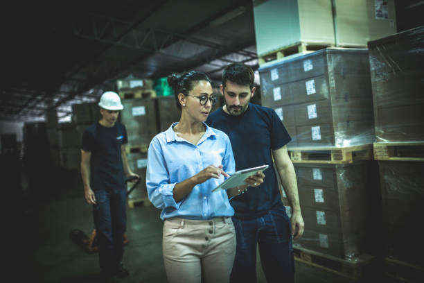 istock Warehouse supervisor walking and talking with senior manager 1160701237