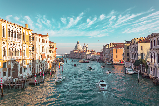 Grand Canal in Venice, Italy. View of the main street panorama of the major street of Venice, picturesque clouds in the sky. Basilica di Santa Maria della Salute