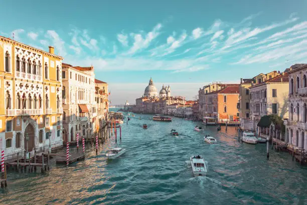 Photo of Grand Canal in Venice, Italy. View of the main street panorama of the major street of Venice, picturesque clouds in the sky. Basilica di Santa Maria della Salute.