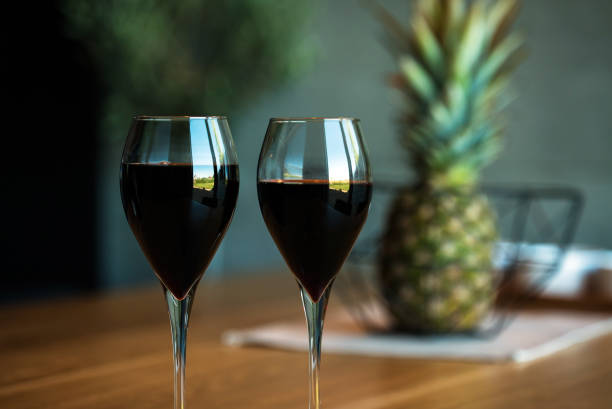 Pouring red wine on a wooden oak table