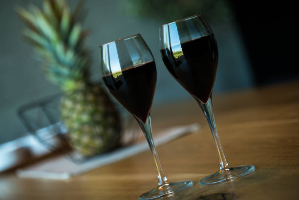 Pouring red wine on a wooden oak table