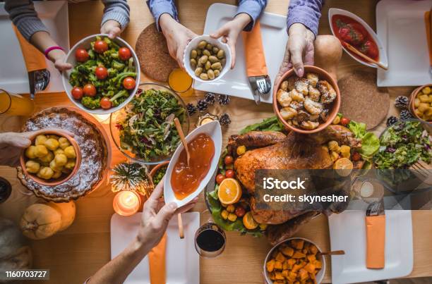 Above View Of Passing Food During Thanksgiving Dinner Stock Photo - Download Image Now