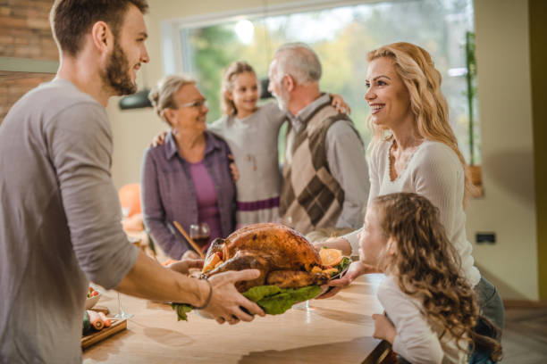istock Happy family making final preparation on Thanksgiving day. 1160704957