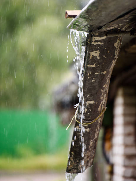 istock Storm rain drips down from the roof 1160712180