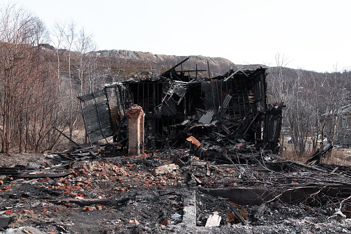 The old wooden damaged burned-down house a view from inside