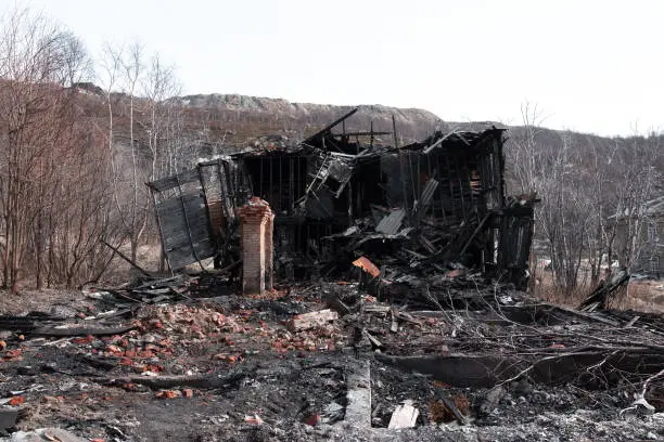 Photo of The old wooden burned-down house a view from inside