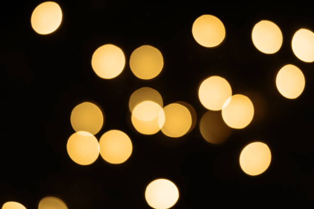 istock Black festive background with shining golden bokeh lights 1160714724