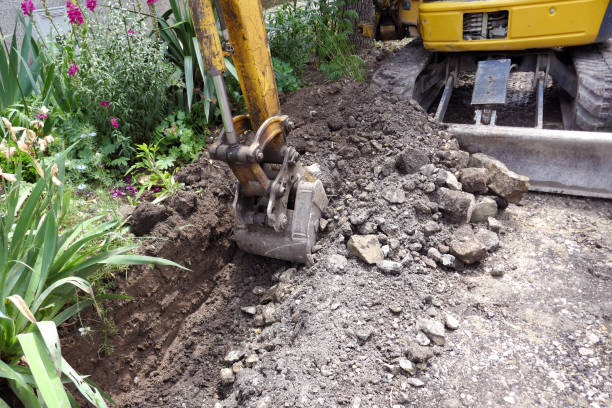 istock Small excavator is excavating soil at construction site, project in progress 1160715648