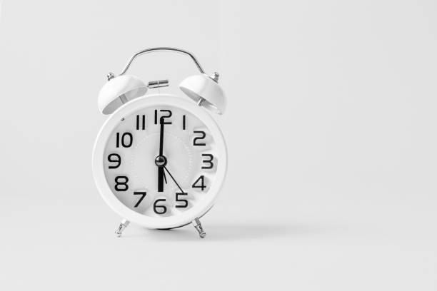 istock White vintage alarm clock on white background. 1160715775