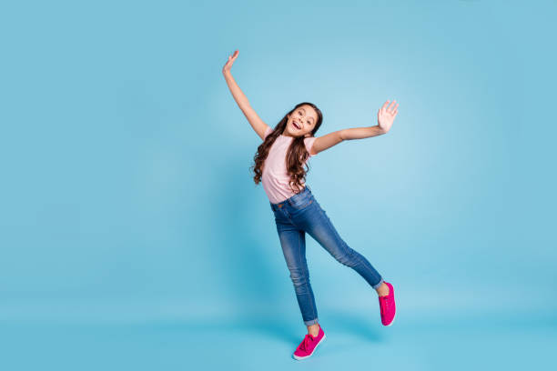 full length body size view charming cute child have free time holidays laugh laughter feel content rejoice stylish trendy dressed fashionable jeans t-shirt fuchsia sneakers isolated blue background - carefree joy children only pre adolescent child imagens e fotografias de stock
