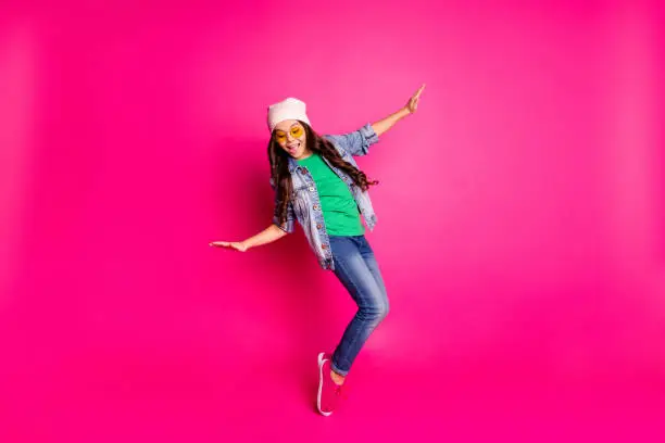 Photo of Close up photo beautiful little age she her curly lady cool arms hands action motion disco party amazing look long hairdo wear yellow specs casual jeans denim jacket isolated pink bright background