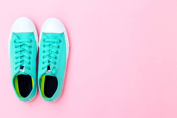 istock Feminine green sneakers on pink background. Copy space 1160722952