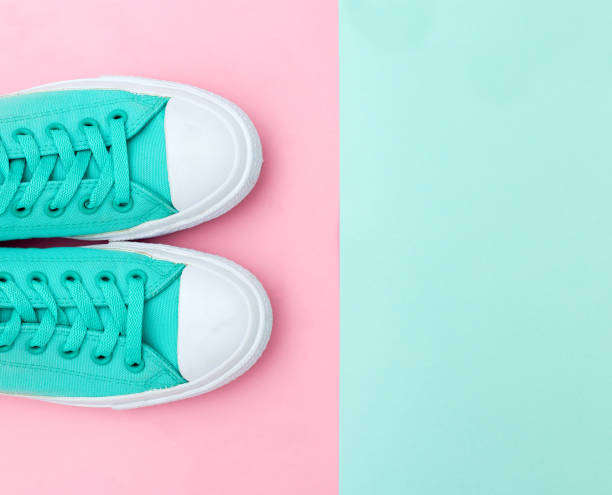 istock Green sneakers on pastels background. Copy space. Minimal Style 1160722969