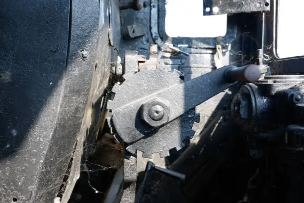 Detail shot of steam boiler of steam locomotive built in 1920. cover and gear arm.