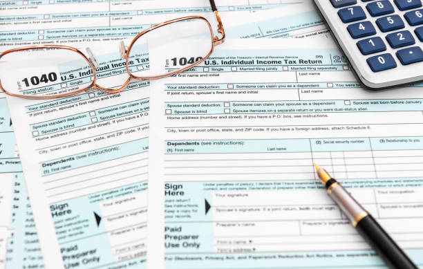 istock 2018 IRS form 1040 with calculator and pen 1160728999