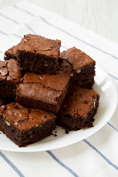 istock Homemade chocolate brownies on a white plate, low angle view. Closeup. 1160729079