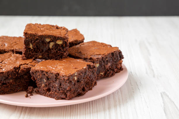 istock Homemade chocolate brownies on a pink plate, low angle view. Close-up. Copy space. 1160729769