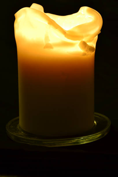 istock Burning candle on a black background - flame photography 1160730911