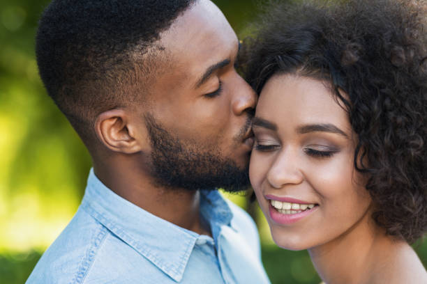 istock Loving black man kissing his girlfriend while walking 1160733527
