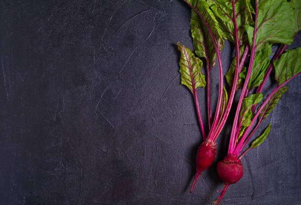 istock Beet - root vegetables on a black background. Summer farm vegetables. Food background, layout, room for text 1160733566