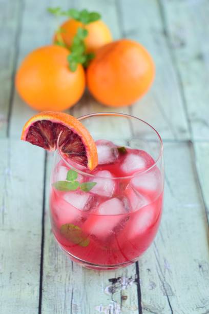 istock Blood orange cocktail drink with ice cubes and mint leaf 1160733604